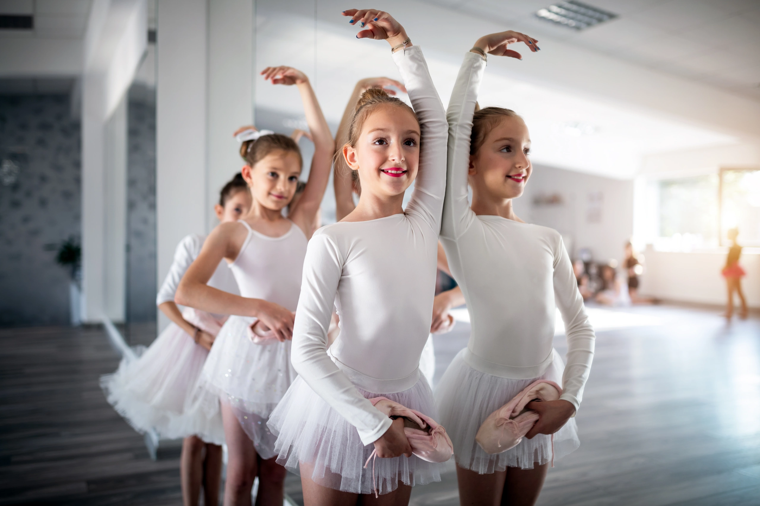 Young ballet students practicing in dance studio, enhancing student retention - Opus1: Everything You Need to Run Your School in One Place