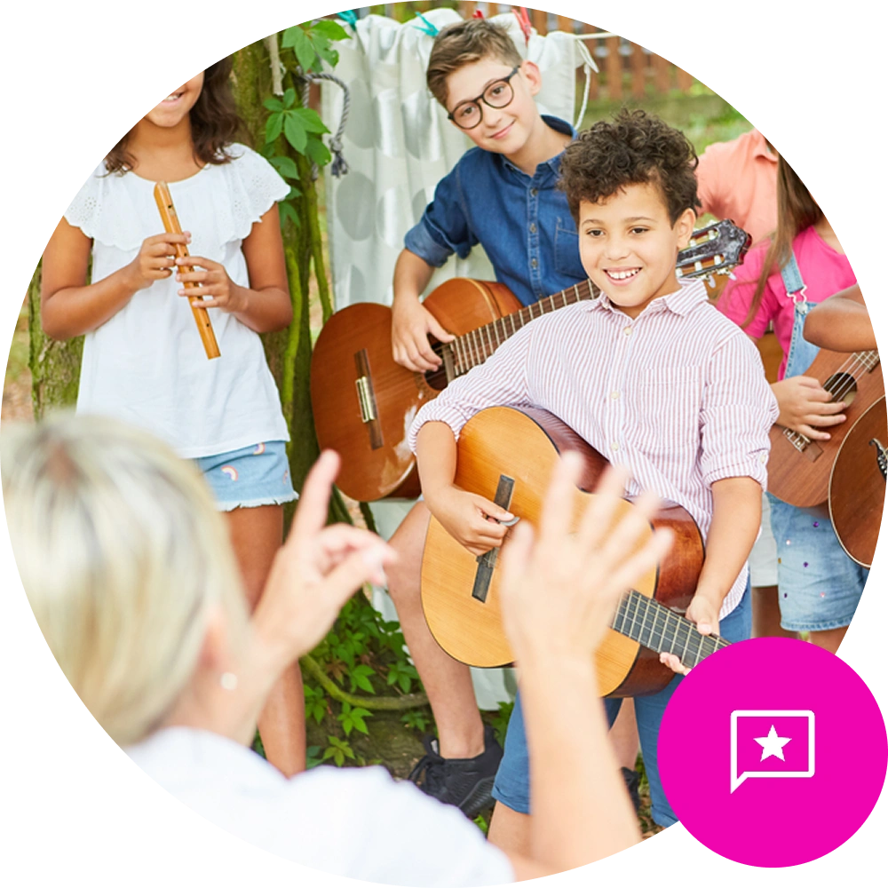 Young children holding guitars in music class, looking at the teacher - Reputation / Review Icon in the bottom right on brand pink background