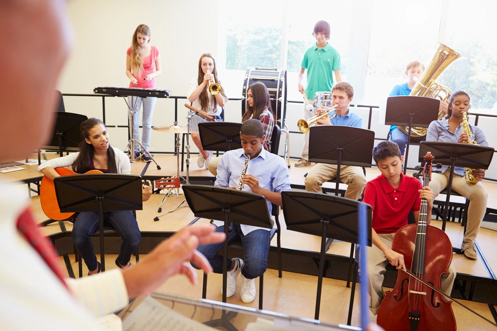 Highschool band class - kids with various musical intruments on risers