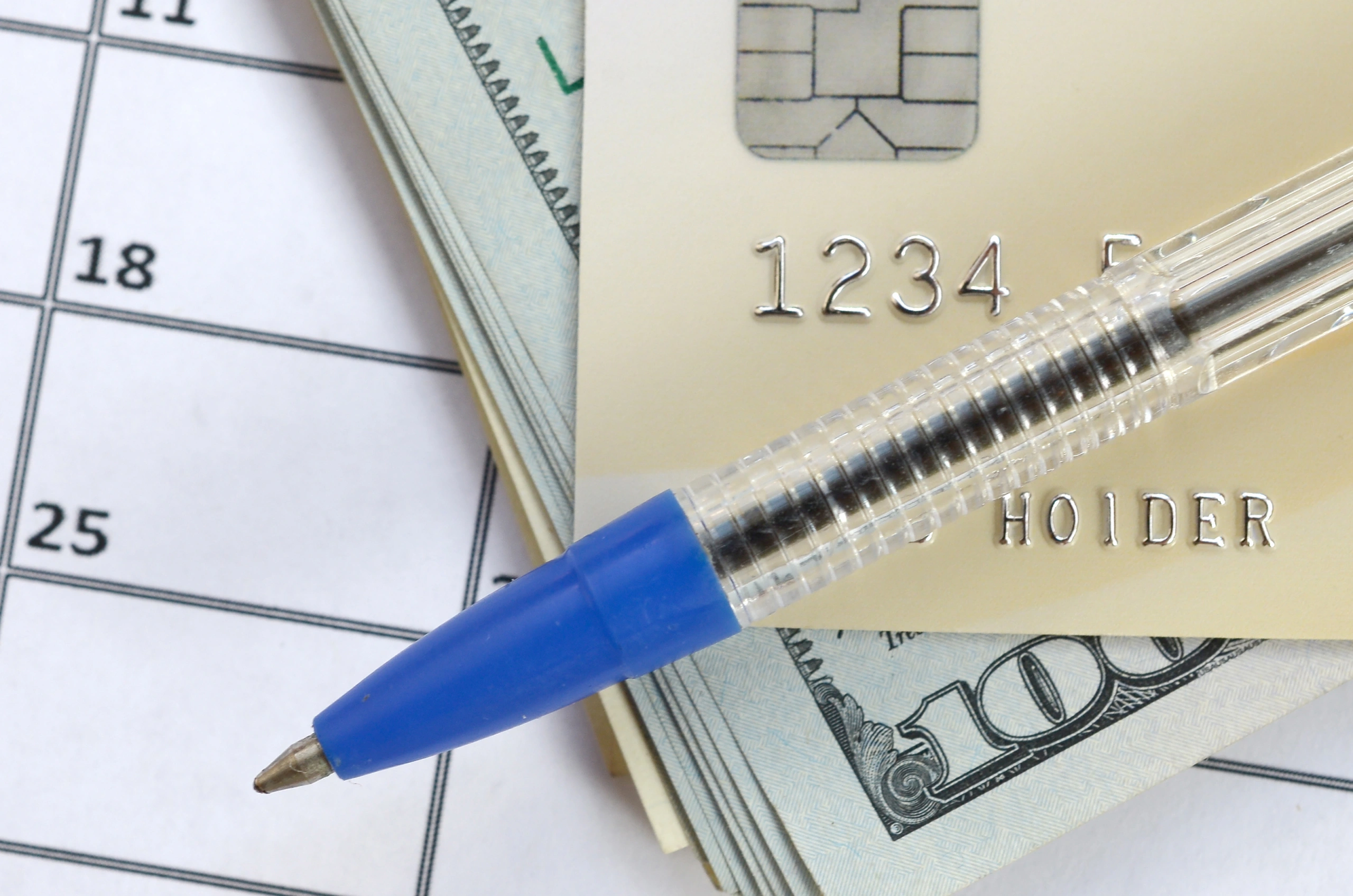 Credit card and dollar bills symbolizing monthly billing for music schools with Opus1 automation