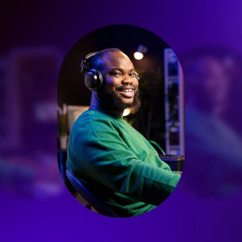 Man in green sweater sitting with headphones on