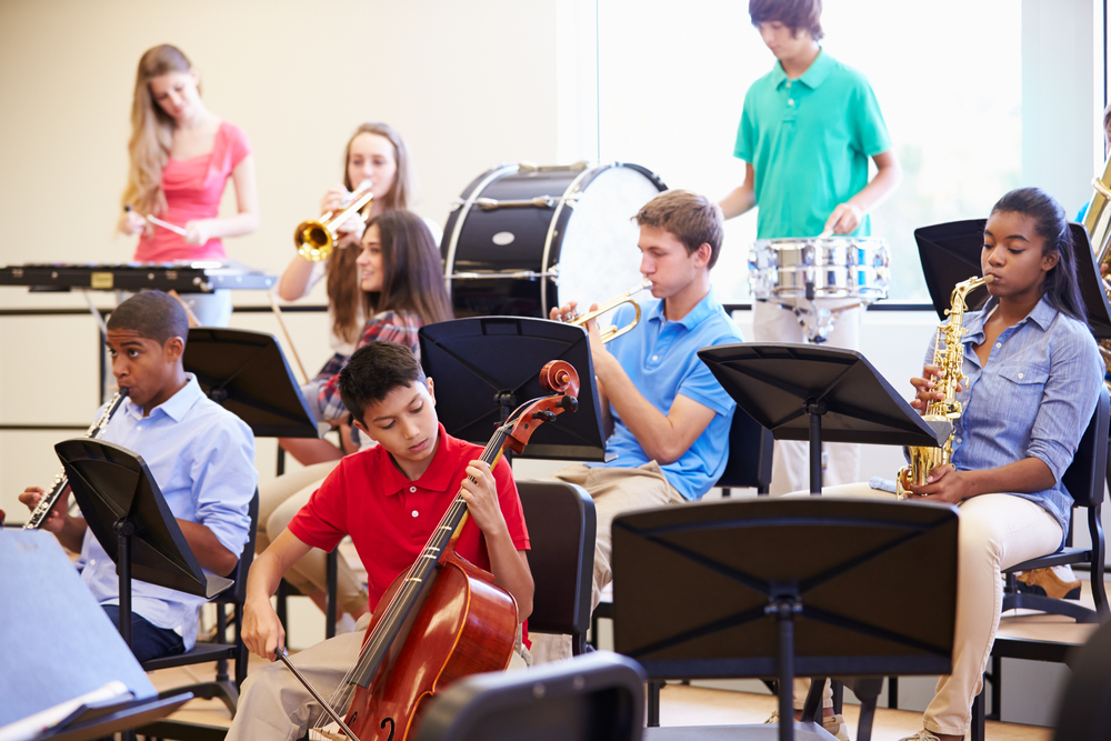 Students in music class playing various instruments