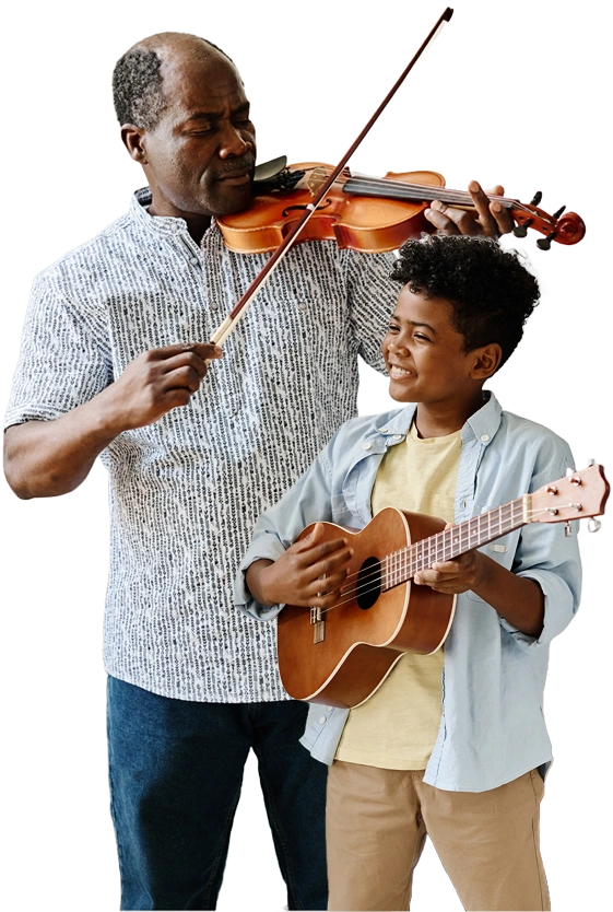 Older man playing violing standing behind child playing guitar during lessons