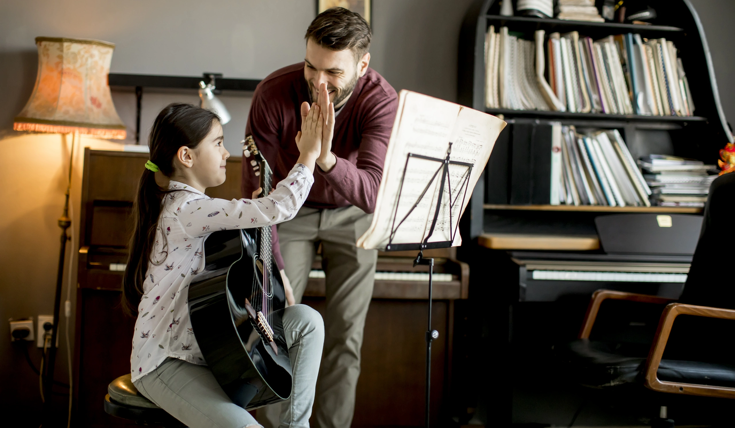 Guitar teacher with student