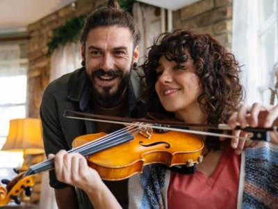 Woman playing violin with teacher