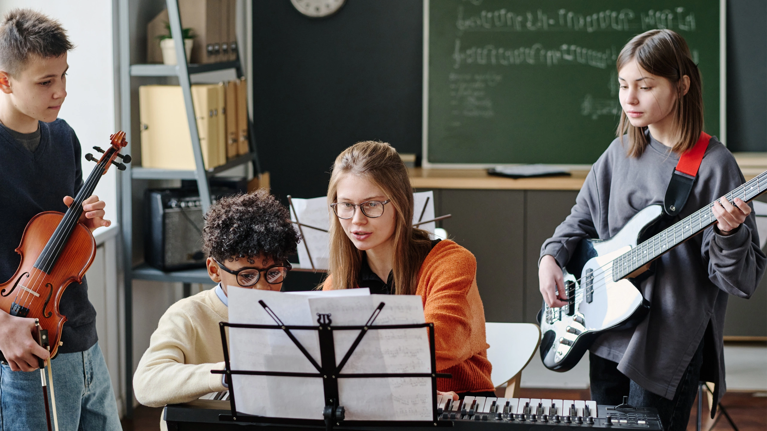 Students learning music with instruments.
