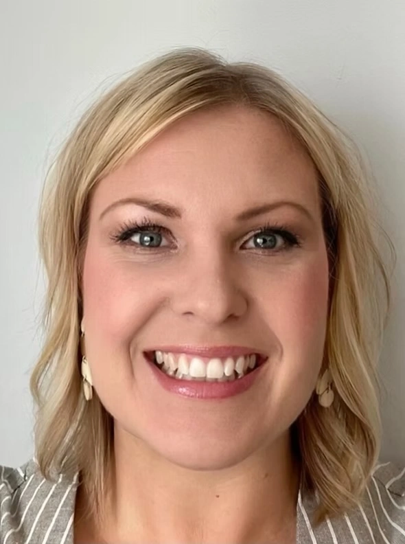 Marla Morrison headshot, smiling in a striped shirt