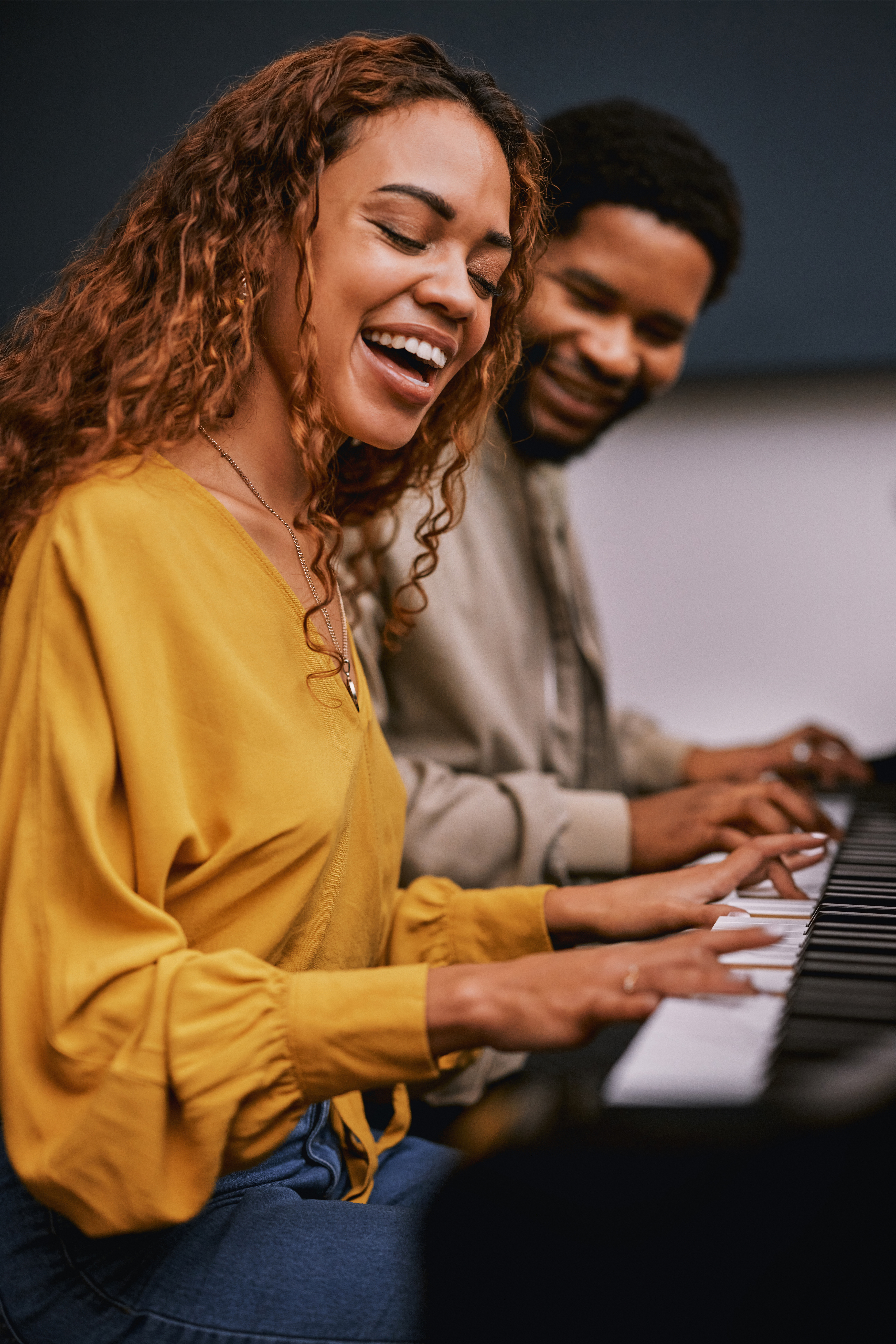 Two people enjoying piano lessons at a music school - Opus1: Everything You Need to Run Your School in One Place