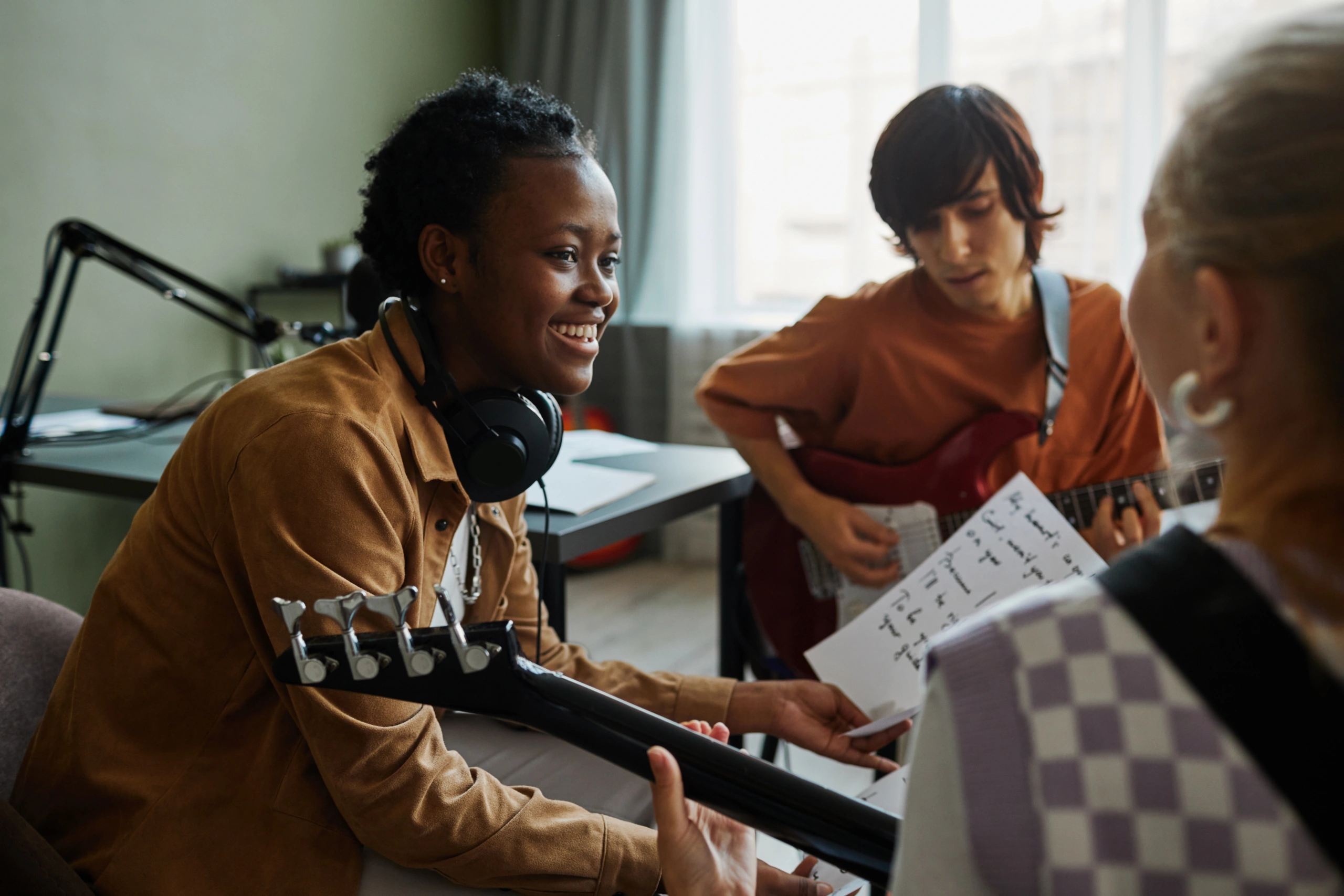 Guitar Lesson at Music School – Opus1: Everything You Need to Run Your School in One Place Students at music school using reporting software during guitar lesson - Opus1: Everything You Need to Run Your School in One Place