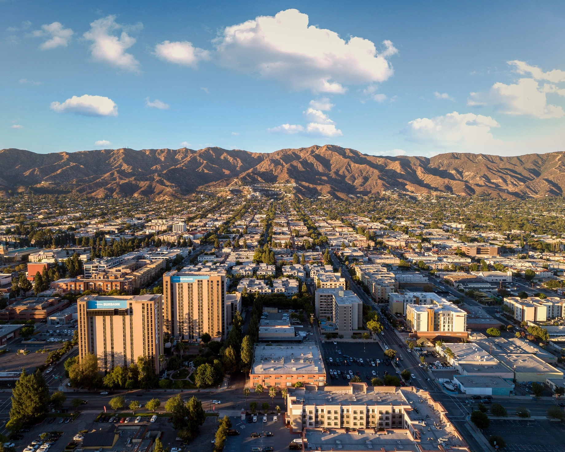 Aerial view of Burbank, California with mountains and cityscape at sunset - Opus1: Everything You Need to Run Your School in One Place
